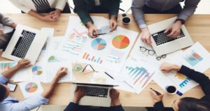 AMBCrypto An image of a group of people gathered around a table 33e99d0f 3895 489b afc6 eb260d6a250c